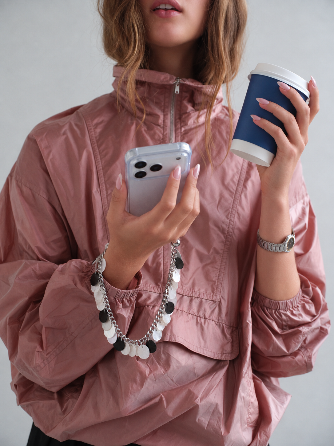 Pearl Shells phone chain worn on the wrist with an iPhone in a clear Snazz case